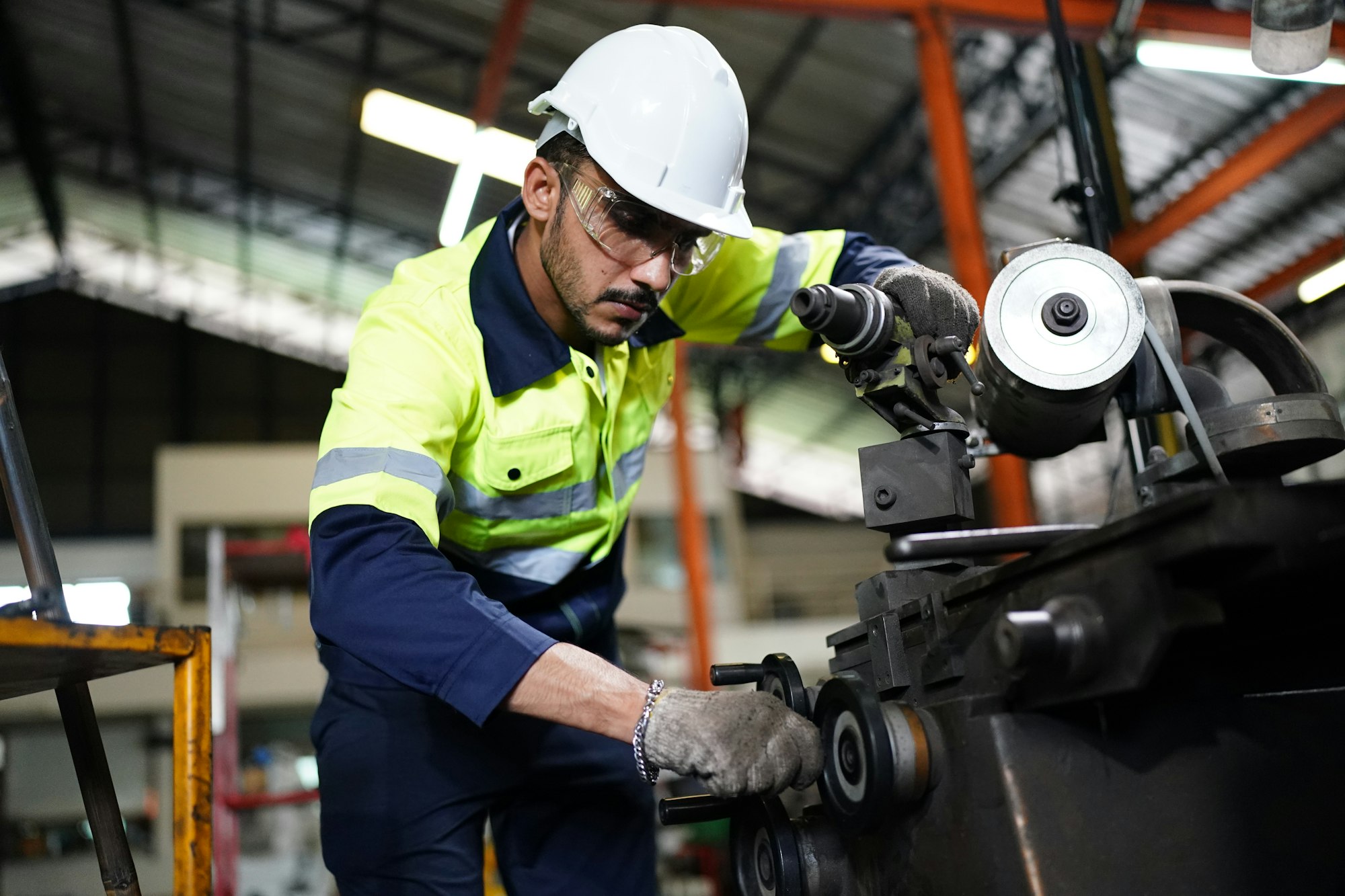 industrial factory worker working in metal manufacturing industry